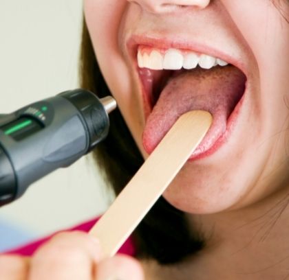 Female open mouth with tongue depressor