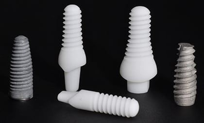 An image of both titanium and zirconia dental implants